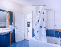 a kitchen with a blue shower curtain